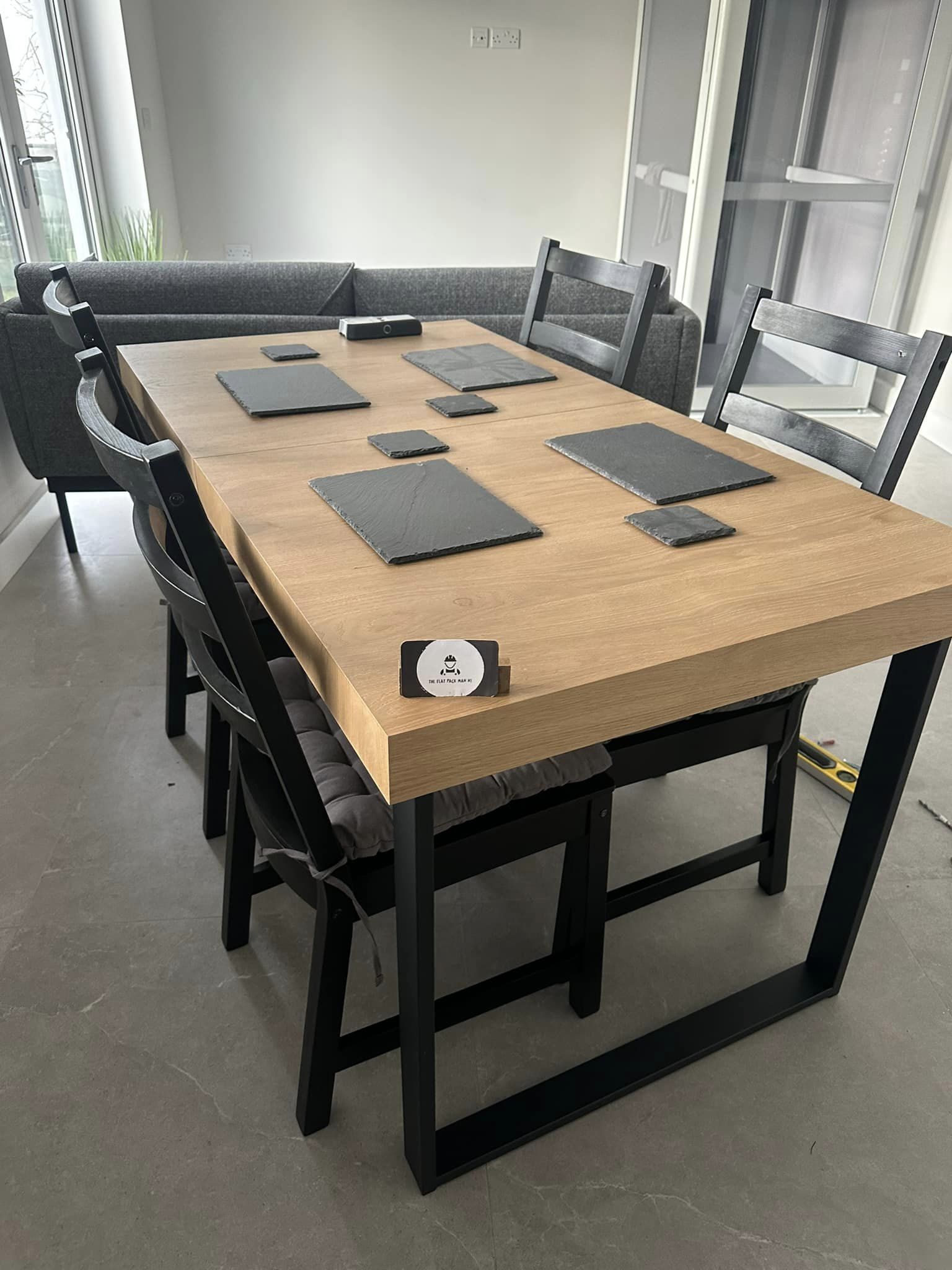 think wooden table top with black metal legs